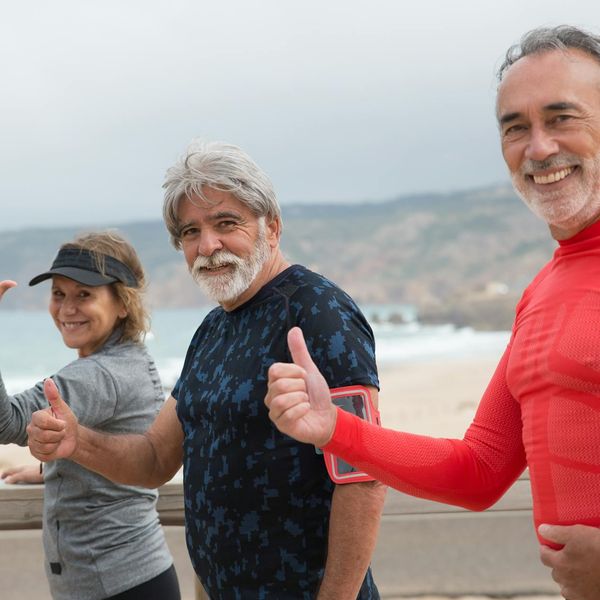 A group of people smiling and feeling energetic during a fitness class.